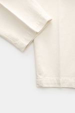 Close-up front view of Michael Coal Cotton Pants cream, showing twill cotton fabric, soft touch, tapered fit, regular thigh width, ankle length narrowing, zipper and waistband hook, extended button tab, French pockets, and back pockets with flap.