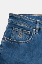 Nahaufnahme der Moorer Jeans 'Milton' rauchblau von schräg oben, elastischer Denim, Used-Waschung, Five-Pocket-Stil, Sticklogo Münztasche.