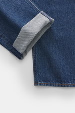 Close-up from above of Stone Island Jeans 'Indigo Denim - Medium Grainy Wash' dark blue showing folded cuff and detailed texture with subtle used wash.
