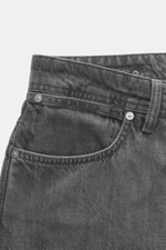 Stone Island Jeans 'Black Denim - Light Grey Wash' grey close-up from front top side showing button fly, five-pocket, pure cotton denim with subtle wash.