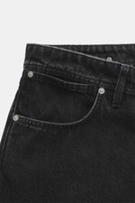 Close-up front view of Stone Island Jeans 'Black Denim - Medium Grainy Wash' black, showing straight cut waistband, button fly, and five-pocket style. Denim made of pure cotton with typical material structure and subtle used wash. Compass badge on the wai