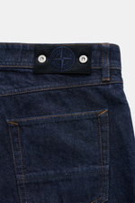 Stone Island Jeans 'Indigo Denim - Rinsed' dark blue shown from the back waist close-up, highlighting the compass badge. An urban classic in a modern silhouette: The straight fit jeans 'Indigo - Rinsed' from the 'Denim' capsule collection by STONE ISLAND 