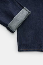 Close-up view of Stone Island Jeans 'Indigo Denim - Rinsed' dark blue showing the cuff folded to reveal the inner fabric texture and stitching details.