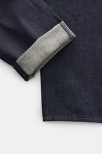 Close-up view of Stone Island Jeans 'Indigo Denim - Raw' navy showing folded cuff and textured raw cotton denim fabric with orange stitching.

Description: <p>Urban classic in a modern silhouette: The 'Indigo Denim - Raw' jeans from STONE ISLAND's Denim c