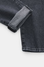 PT Torino Denim Jeans 'Breakbeat' dunkelgrau, Detailaufnahme aus schräger Perspektive, Denim aus reiner Baumwolle, weicher Griff, Slim Fit, Used-Waschung, sehr schmal zulaufend, Zip Fly, Five-Pocket-Stil, Leather Patch.