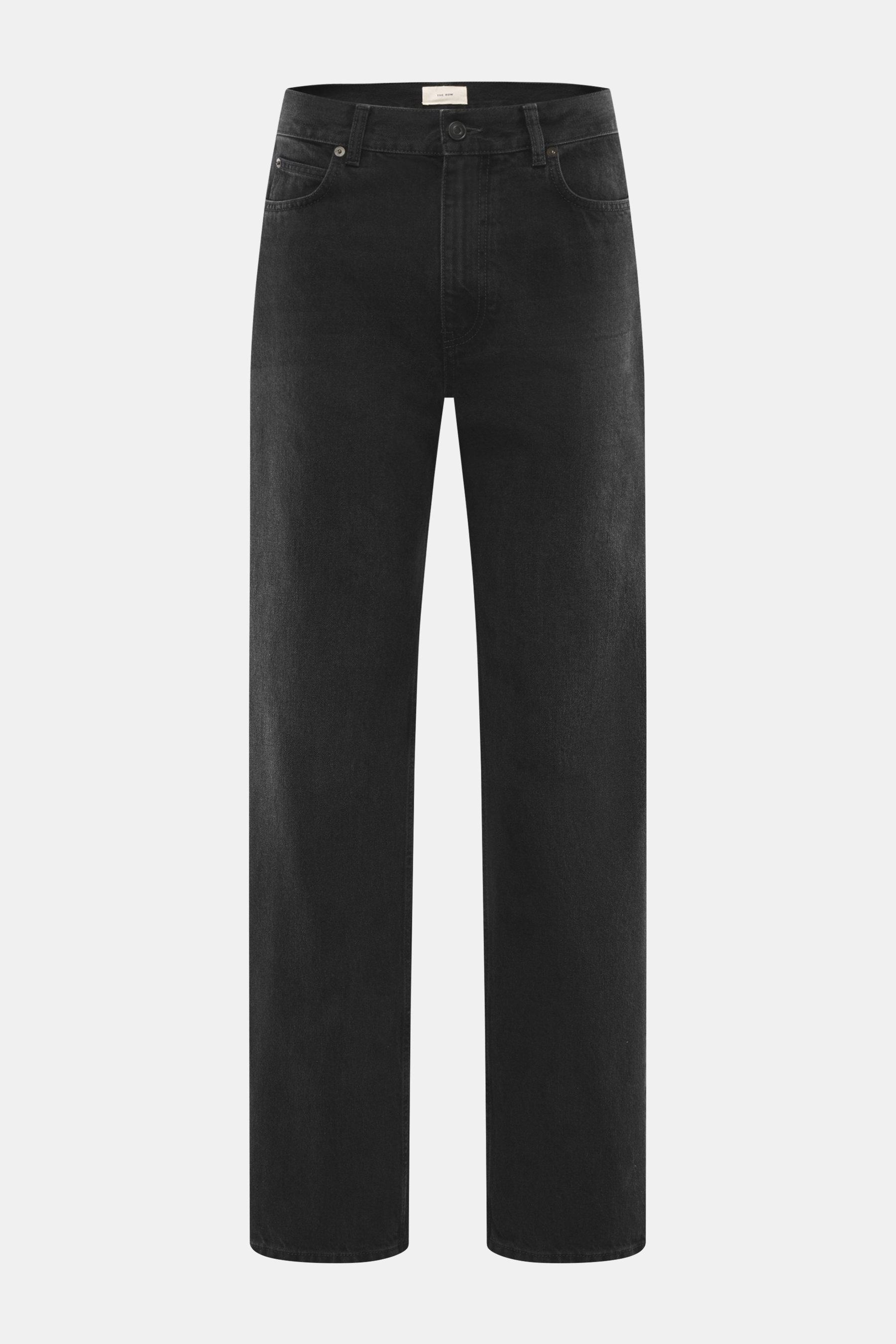 The Row Jeans 'Vanya' schwarz, frontal fotografiert, schwarz-texturierter Denim mit subtilen Tonabstufungen, Five-Pocket-Stil, Zip-Fly, gerader Schnitt, knöchellang, Tapered Fit, reine Baumwolle.