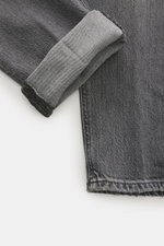 Close-up top view of Dondup Jeans 'Icon Relax' grey showing pure cotton fabric with slightly textured feel, authentic used wash, modern distressed effects, Icon Fit (Slim Fit), narrow-cut thigh, tapered fit, short cut, button fly, and five-pocket style.