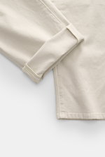 Close-up of the cuff area of Barmas Venezia Jeans 'Denver' beige, showing denim made from cotton with cashmere, slightly elastic quality, soft touch, regular fit, tapered slim fit, five-pocket style, button fly, and embossed leather patch, photographed fr