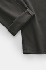 Close-up view of the cuff of Barmas Venezia Jeans 'Denver' grey, showing denim made from cotton with cashmere, slightly elastic quality, soft touch, regular and tapered fit, five-pocket style, button fly, and embossed leather patch.
