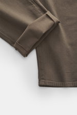 Close-up view of the Barmas Venezia Jeans 'Denver' brown cuff, showing denim made from cotton with cashmere, slightly elastic, soft touch, regular tapered slim fit, five-pocket style, button fly, and embossed leather patch.