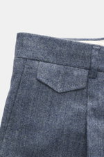 Close-up front-side view of Windsor Trousers 'Silvi' smoky blue melange showing textured wool-cashmere-microfibre fabric, shaped fit with tapered cut, simple pleats, French pockets, small watch pocket with flap, and back pockets with button. The label WIN