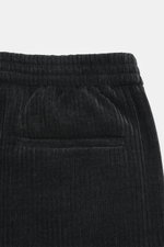 Close-up rear view of Emporio Armani Cord jogpants black showing elastic waistband with button, piped welt and back pockets, made of high-quality microfiber with soft touch and tapered fit.
