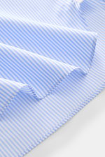 Close-up of the Borrelli Business Shirt 'Luciano' Shark Collar blue/white striped fabric from a side angle, showing fine twill cotton, light smooth feel, timeless stripes, and precise stitching, highlighting masterful craftsmanship and exclusive handmade 