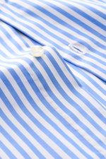 Close-up from above of the Borrelli Business Shirt 'Luciano' Shark Collar blue/white striped fabric, showcasing the rare Sakellaridis cotton, mother-of-pearl button, and fine twill texture. Masterful craftsmanship with handcrafted details highlights this 