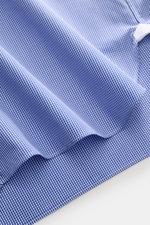 Close-up front-angle view of Borrelli Business shirt 'Nando' shark collar dark blue/white checked, showcasing fine cotton poplin, slim fit, French button placket with mother-of-pearl buttons, soft smooth feel, classic sport cuff, back waist darts, and rou