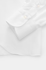 Close-up front-side view of Finamore Business Shirt 'Sergio Napoli' Shark Collar White cuff, made of smooth twill from pure Egyptian Giza-45 cotton with French button placket, classic sport cuff, extra-long sleeves, regular fit, and rounded hemline. Styli
