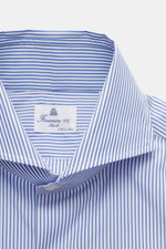 Close-up front view of the Finamore Business Shirt 'Sergio Napoli' Shark Collar blue/white striped, showcasing the smooth, pure Giza cotton fabric, shark collar, French placket, classic sport cuff, extra-long sleeves, regular fit, and rounded hemline, hig