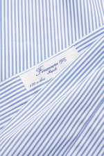 Close-up top view of Finamore Business Shirt 'Sergio Napoli' Shark Collar blue/white striped label, showcasing pure Giza cotton fabric with smooth touch. Confident style at the office: The 'Sergio Napoli' shirt by FINAMORE impresses with rare Egyptian Giz