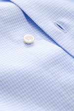 Close-up front angle of the Fray Shirt Shark Collar 'Nello' light blue/white checked showing button and buttonhole detail on a pure cotton slim fit shirt with slightly textured feel, classic check pattern, shark collar, classic sport cuff, and slightly ro