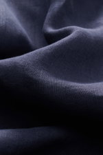 Close-up front view of navy fabric texture of von Braun Linen shirt shark collar navy, showcasing its airy, lightweight pure linen weave with a relaxed, soft feel and garment-dyed finish. Effortlessly lightweight: This VON BRAUN shirt in pure linen has an