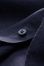 Close-up front angle of von Braun Linen shirt shark collar navy showing navy button, pure linen texture, and garment-dyed fabric.

<p><span class="_fadeIn_m1hgl_8">Effortlessly </span><span class="_fadeIn_m1hgl_8">lightweight</span><span class="_fadeIn_m1