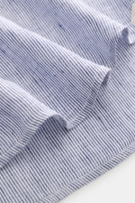 Close-up top-down view of the von Braun Linen shirt shark collar navy/white striped fabric showing fine stripes, airy texture, and soft linen weave, highlighting its relaxed, lightweight feel.

<p><span class="_fadeIn_m1hgl_8">Effortlessly </span><span cl