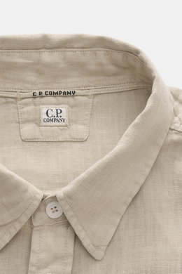 Close-up front top view of C.P. Company Linen shirt narrow collar sand, showing narrow collar, patch button placket, and linen texture. <section class="text-token-text-primary w-full focus:outline-none [--shadow-height:45px] has-data-writing-block:pointer