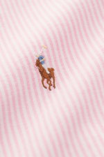 Close-up front view of the Polo Ralph Lauren Oxfordhemd Button-Down-Kragen rosé/weiß gestreift showing soft cotton fabric with pink and white stripes and embroidered logo.

<p>Zeitloser Allrounder: Das Oxford-Hemd von POLO RALPH LAUREN verbindet klassisch