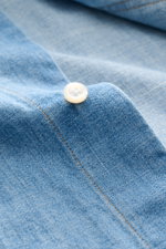 Nahaufnahme des Thom Browne Jeanshemd Button-Down-Kragen rauchblau aus reiner Baumwolle mit Knopf, Regular Fit, Streifen-Print am Ärmel.