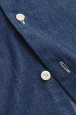 Close-up front view of Giampaolo Chambray shirt shark collar dark blue showing soft cotton fabric, white buttons, and buttonhole.

Description: 
<p>Masterful craftsmanship by hand: GIAMPAOLO makes this chambray shirt from high-quality cotton – for an espe