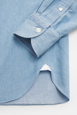 Close-up front view of the Giampaolo Chambray Shirt Button-Down Collar blue melange cuff and hem, pure cotton, soft touch, slim fit, button-down collar, French placket, classic sport cuff, back waist darts, rounded hemline.