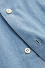 Close-up photograph of the Giampaolo Chambray Shirt Button-Down Collar blue melange sleeve showing pure cotton fabric, soft touch, slim fit, button-down collar, French placket, classic sport cuff, back waist darts, and rounded hemline details.