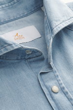 Close-up front view of the Ace Denim Denim shirt smoky blue showing narrow collar, applied snap button placket, pure cotton, soft touch, slim fit, applied chest pockets, western-style yoke, classic sport cuff, and rounded hem.