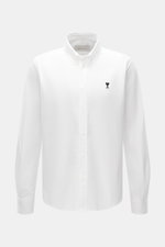 A front view of the Ami Paris Oxford Shirt Button-Down Collar White, classic modern interpretation, pure cotton with textured feel, regular fit, button placket, sport cuff, logo stitching, and rounded hemline.
