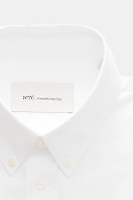 Ami Paris Oxford Shirt Button-Down Collar White shown from the front close-up, classic modern design, pure cotton, slightly textured feel, regular fit, button placket, classic sport cuff, typical logo stitching, slightly rounded hemline. Classic modern in