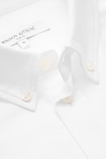 Maison Kitsuné Oxford shirt button-down collar white shown close-up from front angle, features pure cotton Oxford fabric, soft feel, regular fit, button-down collar, signature logo stitching, classic barrel cuffs, inverted pleat on back, and rounded hem.