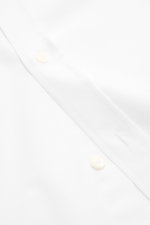 Maison Kitsuné Oxford shirt button-down collar white shown close-up from front angle, pure cotton Oxford fabric, soft feel, regular fit, button-down collar, signature logo stitching, classic barrel cuffs, inverted pleat on back, rounded hem.