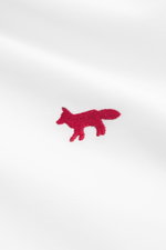 Maison Kitsuné Oxford shirt button-down collar white shown in close-up from front angle, featuring pure cotton Oxford fabric, soft feel, regular fit, button-down collar, signature red logo stitching, classic barrel cuffs, inverted pleat on back, and round