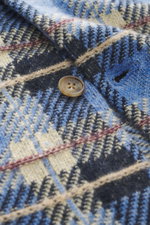 Close-up front view of Guest In Residence Cashmere knit shirt blue/navy/sand checkered showing pure cashmere, soft touch, medium-fine knit pattern, regular fit, smooth button placket, turn-down collar, breast pockets with flap and button, and short hem sl