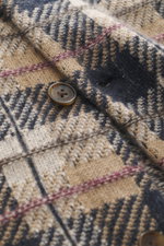 Close-up front view of the Guest In Residence Cashmere knit shirt light brown/beige/navy checkered showing pure cashmere fabric, soft feel, medium-fine knit pattern, smooth button placket with branded button, turn-down collar, breast pockets with flap and
