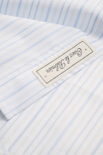 Close-up front view of Jacquemus Casual shirt kent collar light blue/white striped, pure cotton with soft, smooth feel, fine stripe pattern with logo woven detail, oversized fit, Kent collar, concealed button placket, initial patch on chest, pin tuck, cla