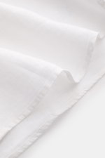 Close-up front angle of Vilebrequin Linen shirt slim collar white showing lightweight fabric, soft feel, regular fit, narrow collar, French button placket, classic barrel cuffs, patch breast pocket, rounded hem, and tonal stitching on the hem.