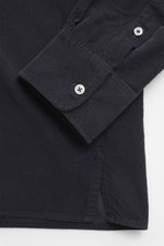 Close-up side view of Officine Générale Corduroy shirt kent collar navy, showing corduroy pure cotton fabric, soft touch, regular fit, kent collar, French button placket, classic sport cuff, and short hem slits.