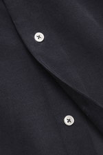 Close-up front view of Officine Générale Corduroy shirt kent collar navy, showing corduroy made of pure cotton, soft touch, regular fit, kent collar, French button placket, classic sport cuff, and short hem slits.