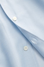 Close-up front angled view of the Gherardi Casual shirt shark collar light blue, showing twill cotton-cashmere soft flannel fabric, slim fit, French button placket, classic sport cuff, split back yoke, rear waist darts, and rounded hemline.