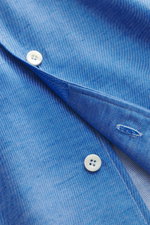 Close-up front view of Gherardi Casual shirt shark collar blue melange showing white button on soft flannel twill made of cotton and cashmere, slim fit with classic sport cuff, french button placket, split back yoke, rear waist darts, and rounded hemline.