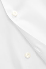 Close-up front view of Gherardi Casual shirt shark collar white, showing elastic cotton fabric, soft touch, lightweight quality, slim fit, shark collar, French placket, classic sport cuff, back waist darts, and rounded hem.