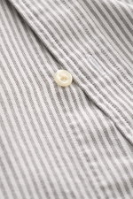 Close-up front view of Polo Ralph Lauren Oxford Shirt Button-Down Collar Black/White Striped showing striped pure cotton fabric, button, and detailed chest stitching. Stylish classic with attention to detail: This sporty shirt from POLO RALPH LAUREN is ma