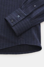 Close-up top-down view of Brunello Cucinelli Jersey shirt shark collar dark blue striped sleeve and cuff with buttons, classic pinstripe pattern.

Description: <p>Clean essential first choice: Lovers of quiet luxury are well equipped with this timeless pi