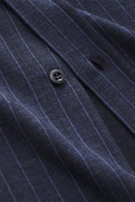 Close-up angled view of Brunello Cucinelli Jersey shirt shark collar dark blue striped showing fabric texture, pinstripe pattern, and button.

Description: <p>Clean essential first choice: Lovers of quiet luxury are well equipped with this timeless pinstr